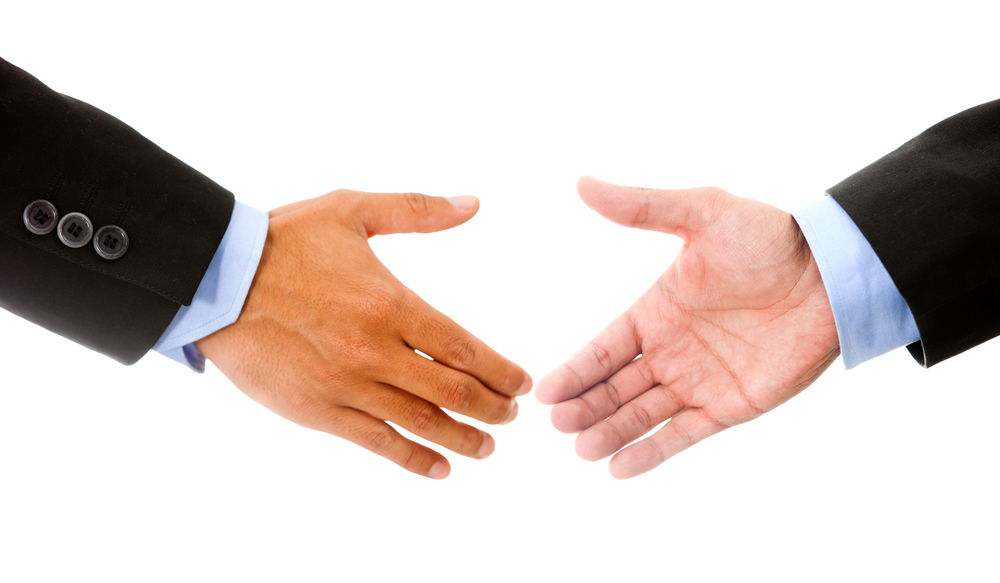 Business handshake - isolated over a white background